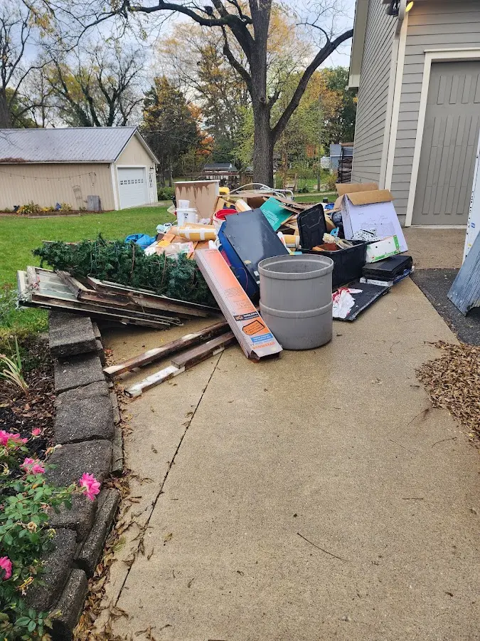 Dumpster being loaded with debris for 12 Yard Dumpster Rental in Lockhart
